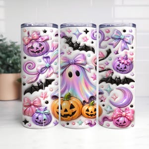 A trio of Halloween-themed tumblers, each adorned with a variety of spooky and festive decorations. The tumblers feature pumpkins, bats, ghostly figures, and other Halloween-related imagery, creating a whimsical and festive atmosphere.