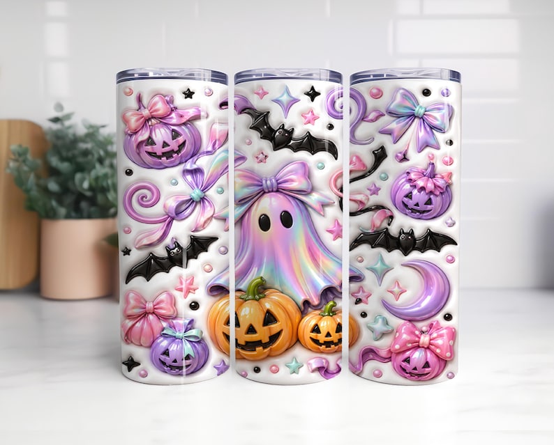 A trio of Halloween-themed tumblers, each adorned with a variety of spooky and festive decorations. The tumblers feature pumpkins, bats, ghostly figures, and other Halloween-related imagery, creating a whimsical and festive atmosphere.