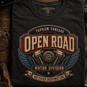 May include: Dark gray t-shirt with a motorcycle-themed graphic. The design features the words "OPEN ROAD" in a vintage style, along with engine illustrations and the text "MOTOR DIVISION". The shirt also includes the text "NO FIXED DESTINATION".