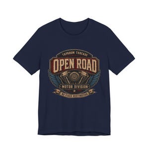 May include: Navy blue t-shirt with a distressed graphic featuring the text "OPEN ROAD" above a motorcycle engine design and wings. The shirt also includes the text "TAPROOM THREADS MOTOR DIVISION NO FIXED DESTINATION".