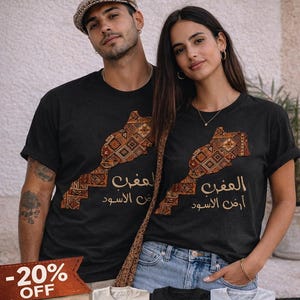 Peut inclure: T-shirts noirs avec une carte du Maroc ornée de motifs décoratifs. Le texte "MOROCCO T-SHIRT" est en haut. L'image présente également quatre options de couleurs et le texte "4 COLORS | UNISEX | 100% COTTON".