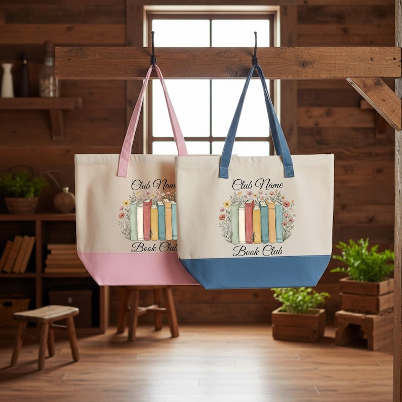 Two tote bags with the text "Book Club" printed on them, hanging from a wooden rack in a room with wooden shelves and plants.