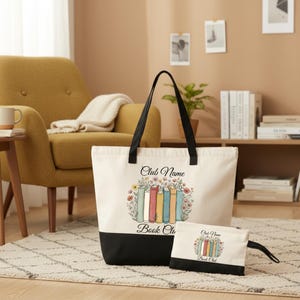 A large tote bag with a printed design of books and flowers, and a smaller book bag with a similar design, placed on a rug in a living room setting.