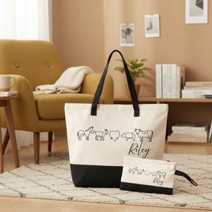 May include: A cream-colored canvas tote bag and a matching zippered pouch, both featuring a black bottom panel and a black line-art graphic of a donkey, goat, heart, pig, and cow, with the name Riley printed in black script on both items.