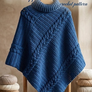 May include: A deep blue crochet poncho featuring a high turtleneck collar and diagonal cable knit patterns. The text "The Sapphire Cable Poncho crochet pattern" is displayed at the top of the image. The garment is draped over a wooden frame.