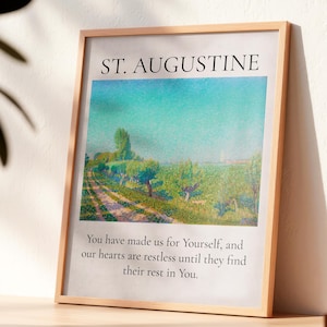 Könnte beinhalten: Gerahmter Kunstdruck mit einem Landschaftsgemälde mit hellblauem Himmel und grünen Feldern. Der Text "ST. AUGUSTINE" steht oben, darunter ein Zitat: "You have made us for Yourself, and our hearts are restless until they find their rest in You."