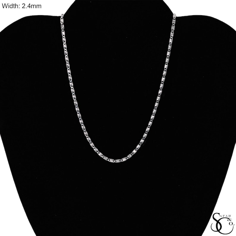 May include: A silver-colored necklace with a delicate chain design, displayed on a black mannequin. The chain's width is 2.4mm. The necklace is a simple, elegant piece of jewelry.