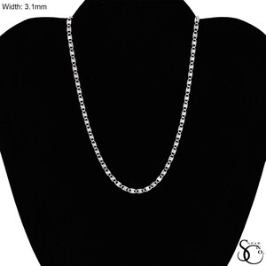 May include: A silver-colored chain necklace with a width of 3.1mm. The chain is displayed on a black mannequin. The necklace has a series of elongated, oval-shaped links.