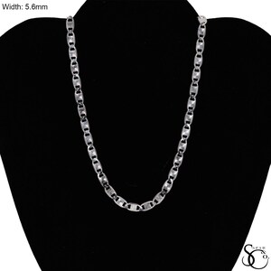 May include: A silver-colored chain necklace with a width of 5.6mm. The necklace is displayed on a black mannequin. The chain links are rectangular and connected in a repeating pattern. The necklace is a jewelry item.