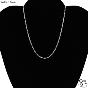 May include: A silver-colored chain necklace with a box link design, displayed on a black mannequin. The chain's width is 1.9mm.