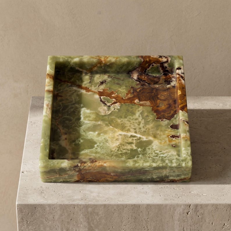 May include: A rectangular tray crafted from polished green onyx stone, featuring natural veining in shades of deep forest green, translucent pale mint, and rich amber brown. The tray has a smooth, glossy finish with thick, solid edges.