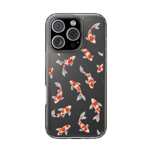 May include: A clear smartphone case featuring a repeating pattern of orange and white koi fish swimming in various directions. The design is printed on a transparent background, allowing the device underneath to remain visible through the clear material.