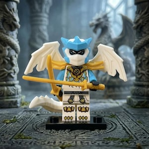 May include: A Lego minifigure of a dragon warrior with a white mask, blue helmet, and gold accents. The figure has white wings and a gold sword. The background features stone pillars and dragon statues, creating a fantasy theme.
