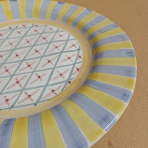 May include: A set of three ceramic mugs with a speckled, matte finish. The mugs are in shades of cream, light gray, and dark gray. Each mug has a simple, minimalist design, perfect for coffee or tea.