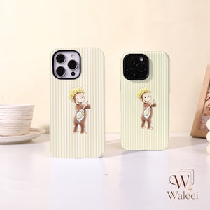 May include: Two phone cases featuring a light yellow and white vertical striped pattern. Each case displays a cartoon monkey wearing a yellow shower cap and holding a scrub brush with soap bubbles on its body, centred on the striped background.