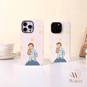 May include: Two phone cases featuring a light pink and white vertical striped background with yellow stars. Each case displays a cartoon monkey wearing blue and white striped pyjamas, holding a small brown teddy bear while standing on a blue dome.