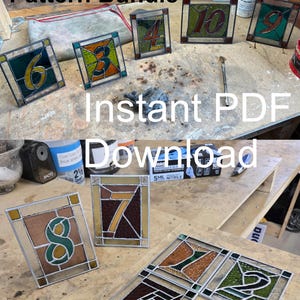 May include: A collection of stained glass table number patterns, numbered 1 through 10. Each square panel features a different number in a unique color scheme, with the text "Instant PDF Download" visible.