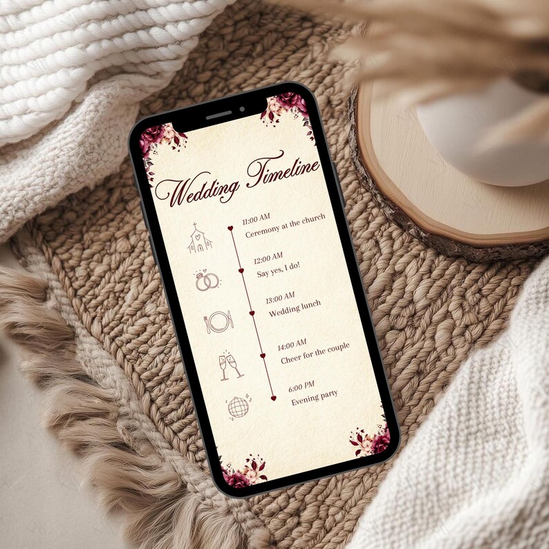 May include: A smartphone displaying a wedding timeline graphic with a cream background, dark red floral accents, and icons for a church, rings, cutlery, champagne glasses, and a disco ball, listing events from 11:00 AM to 6:00 PM in dark brown text.