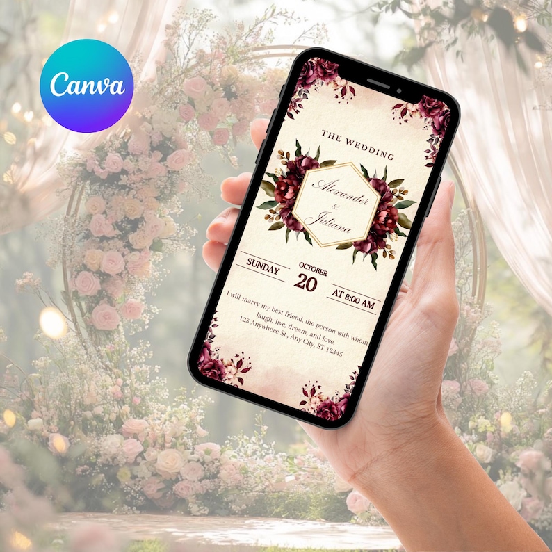 May include: A smartphone displaying a digital wedding invitation with a cream background, dark red floral accents, and a gold hexagonal frame. The text reads: THE WEDDING, Alexander & Juliana, SUNDAY OCTOBER 20 AT 8:00 AM, and address details.