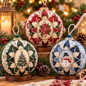 May include: Three spherical fabric ornaments featuring intricate quilted patterns and central embroidered motifs. One displays a red poinsettia, another a green Christmas tree, and the third a snowman. Each ornament rests on a circular wooden base.