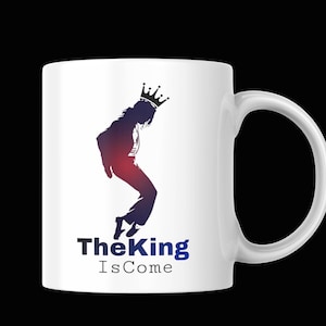 May include: A white ceramic mug with a black handle and the text "But First, Coffee" in a bold, black font. The mug is set against a blurred background, highlighting its clean design. The mug appears to be approximately 4 inches tall.