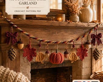 May include: A crochet garland featuring autumn-themed motifs including a central orange pumpkin, red and yellow maple leaves, brown pinecones, and acorns, all suspended from a twisted multi-colored cord with dark red bows at each end.