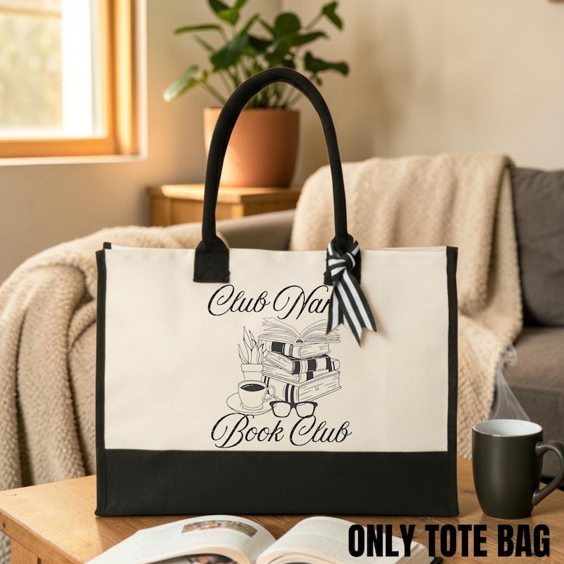 A large tote bag with the text "Club Nana Book Club" printed on it, sitting on a wooden table in a cozy living room setting.