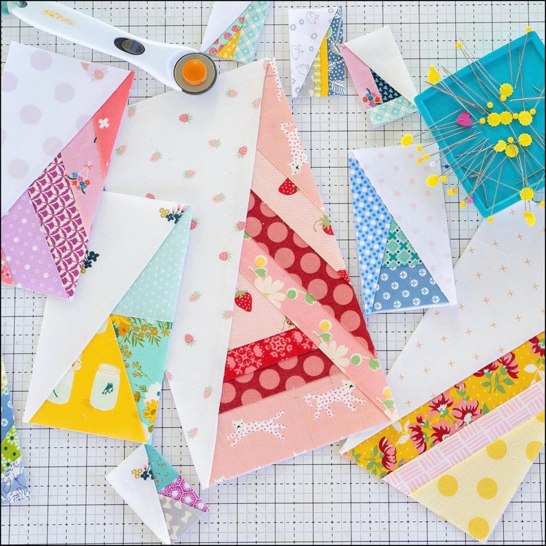 May include: A collection of colorful fabric squares with various patterns, including polka dots, stripes, and floral designs. The squares are arranged in a grid pattern on a white surface.