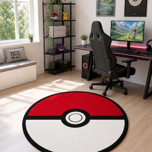 May include: A circular area rug featuring a red and white design with a central black and white circle, mimicking the appearance of a Poké Ball. The rug is positioned on a light-colored wooden floor in a room with gaming furniture and decor.