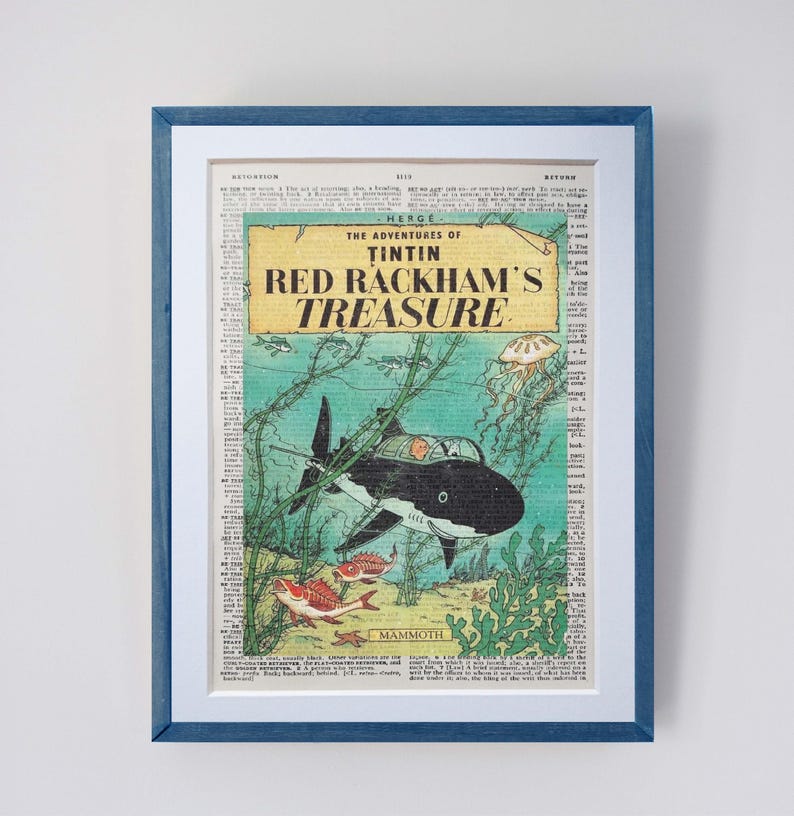 May include: Framed print of a comic book cover, featuring a black and white shark-shaped submarine. The title "The Adventures of Tintin: Red Rackham's Treasure" is displayed in red and black. The print is set against a background of newspaper clippings.