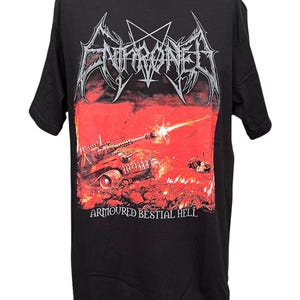 May include: A black short-sleeve t-shirt featuring a graphic print of a tank firing in a fiery red landscape. The text ENTHRONED is printed in a stylised silver font at the top, and the text ARMOURED BESTIAL HELL is printed in white at the bottom.