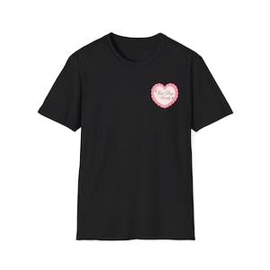 May include: Black t-shirt with a pink heart-shaped graphic on the chest. The graphic has a scalloped edge and the words "Bad Boys Society" in a cursive font.
