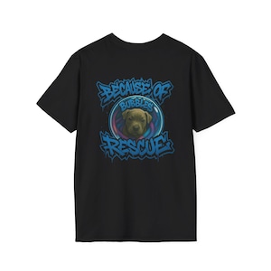 May include: Black t-shirt featuring a graphic of a puppy inside a bubble, with the words "BECAUSE OF BUBBLES RESCUE" in blue graffiti-style lettering. The puppy has brown fur and is looking forward.