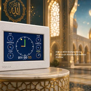 May include: A white rectangular NIDAA digital prayer clock with a screen displaying a central analogue clock, six smaller circular prayer time indicators, and digital time. Text on the screen includes Athan With Multiple Reciters, Full Quran With Multiple Reciters, and Adhkar.
