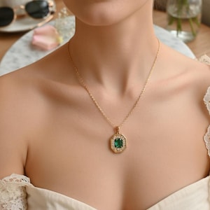 May include: A white ceramic mug with a black handle and the text "But First, Coffee" in a bold, black font. The mug is set against a blurred background, suggesting a cozy setting.