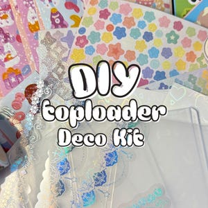 May include: A collection of colorful DIY toploader deco kit supplies. The image features various stickers, washi tape, and clear toploaders. The text "DIY toploader Deco Kit" is displayed in a white, outlined font.