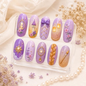 May include: A set of ten lavender-colored artificial nails with various designs. The designs include a sun, a tower, a bow, flowers, and a braid. The nails are displayed on a clear stand.