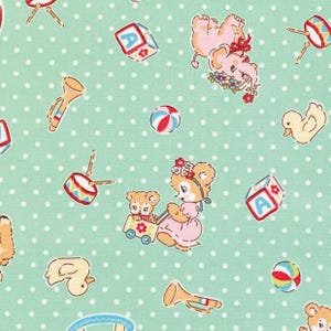 May include: A light mint green fabric featuring a repeating pattern of white polka dots and various toys including teddy bears, yellow ducks, red and blue drums, colorful alphabet blocks, striped balls, and small tan trumpets scattered throughout.