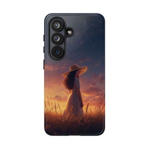 May include: A phone case featuring a digital painting of a person in a white dress and straw hat standing in a wheat field at sunset. The sky transitions from orange to dark blue, with visible stars. The case is black with a camera module.