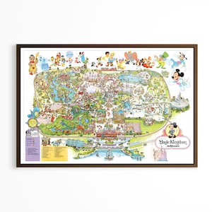 May include: A framed, rectangular map of the Magic Kingdom theme park featuring colorful illustrations of various Disney characters across the top and a detailed layout of the park grounds, including the text Magic Kingdom in the bottom right corner.