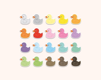 May include: A collection of twenty rubber duck stickers arranged in a grid, each featuring a distinct solid color including shades of gray, yellow, orange, red, pink, purple, blue, green, brown, and black, all with a consistent orange beak.