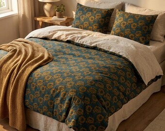 May include: A bed featuring a dark teal duvet cover and two matching pillowcases, all decorated with a repeating yellow sunflower pattern. A light beige flat sheet is folded over the top, and a mustard yellow knit throw blanket is draped.