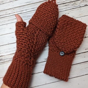 May include: A pair of brown crocheted fingerless gloves with a button on one glove. The gloves are made with a textured stitch.