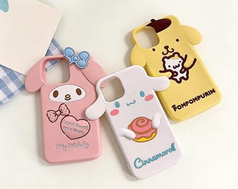 Urocze etui na telefon z postaciami Sanrio w kolorze różowym, białym i żółtym – wypukłe detale, wyraziste twarze i przyjemny w dotyku urok