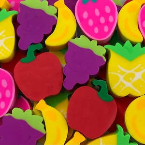 May include: A colorful assortment of fruit-shaped erasers. The image features a variety of fruits, including strawberries, grapes, bananas, apples, and pineapples. The erasers are in bright colors, such as pink, yellow, red, green, and purple.