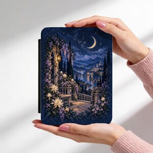 May include: A rectangular e-reader case featuring a dark blue night scene with a crescent moon, starry sky, and a stone balcony adorned with purple wisteria and white flowers overlooking a distant illuminated city and a calm river.