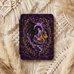 May include: A rectangular e-reader case featuring a dark purple background with a swirling cloud pattern. A large black dragon and a smaller gold dragon are depicted in the center, surrounded by a decorative gold vine frame with small roses.