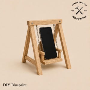 May include: A wooden phone stand shaped like a swing, with a smartphone in place. The stand is made of light-colored wood and has metal chain supports. The text "Lumber Craft Co Woodwork" and "DIY Blueprint" are visible.