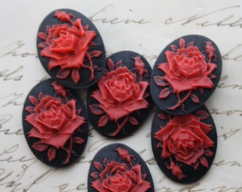 6 ongezette roze cameeën: rood op zwart: 25 x 18 mm