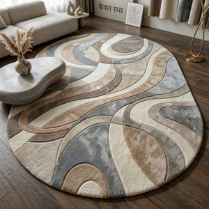 May include: A large, circular rug with a flowing, abstract pattern in beige, grey, and brown tones. The rug has a soft, plush texture and a modern design, suitable for living rooms or bedrooms. The rug's diameter is approximately 200 cm.